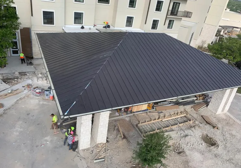 Metal roofing installation team working on a commercial building in Normandy Park